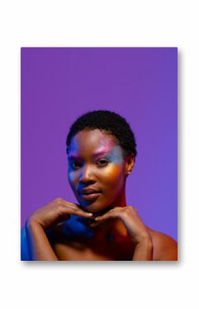 African american woman with short hair, colourful make up and hands under chin, copy space