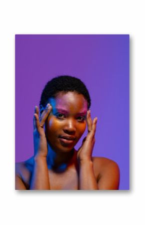 African american woman with short hair and colourful make up touching temples, copy space