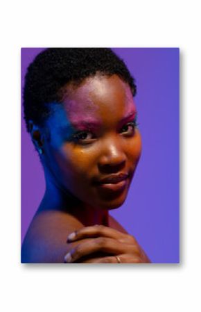 African american woman with short hair and colourful make up with hand on shoulder