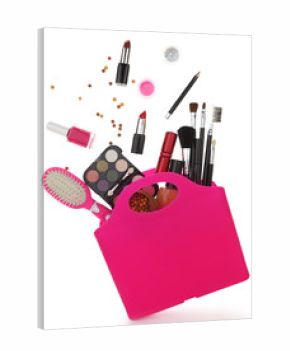 Pink shopping bag with various cosmetics isolated on white
