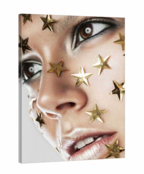 woman with gold stars on face