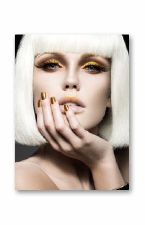 Beautiful girl in a white wig, with gold makeup and nails