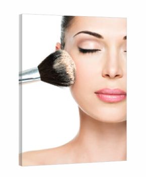 woman  applying dry cosmetic tonal foundation  on the face
