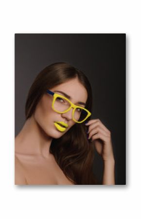 Beauty woman face portrait with yellow lips in yellow sunglasses 