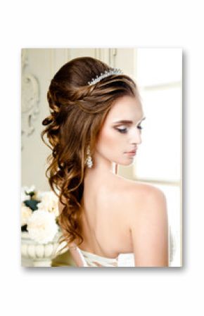 Gorgeous bride in luxury wedding dress. Bride. Perfect Make up. Hairstyle, wedding jewelry. Beautiful Woman with Shiny Brown Hair. gorgeous wedding bouquet of various flowers.