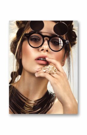 Beautiful fashion woman with creative make-up and hairstyle wearing glasses and jewelry. The beauty of the face. Photos shot in the studio.