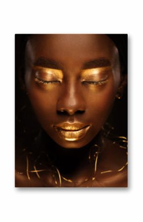 Close up portrait of beautiful african woman with creative gold make–up and jewelry
