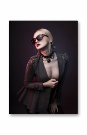 Stylish woman in glasses and on a dark studio background