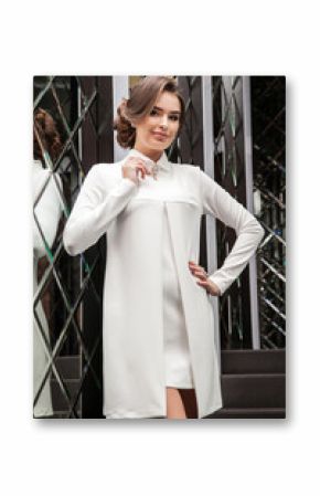 portrait of a beautiful young girl in a white dress on a backgro