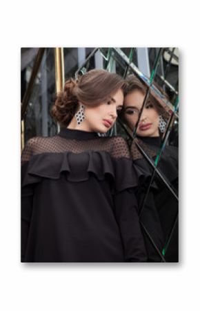 portrait of a beautiful young girl dressed in black on a backgro