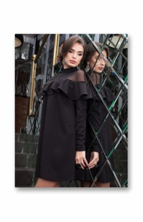 portrait of a beautiful young girl dressed in black on a backgro