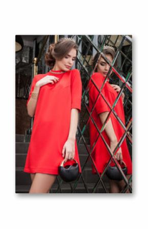 portrait of a beautiful young girl in a red dress on a backgroun