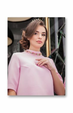 portrait of a beautiful young girl in a pink dress on a backgrou