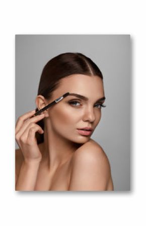 Beautiful Woman Brushing Eyebrows With Brow Tool