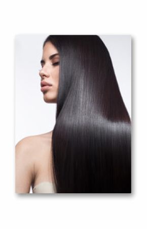 Beautiful brunette girl in move with a perfectly smooth hair, and classic make-up. Beauty face. Picture taken in the studio on a white background.