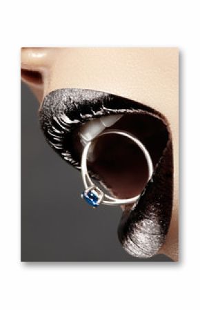 Close-up of beautiful woman's Lips with bright Fashion Make-up. Macro glitter lip gloss. Luxury Jewelry accessorie