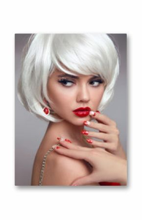 Christmas red lips makeup and Manicured nails. Beautiful blonde girl closeup portrait. White Short bob hairstyle. Sensual blond woman with xmas eye shadow. Vogue style. Studio photo