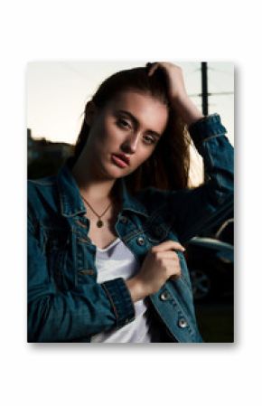 Fashionable brunette stylish model posing on the street in the evening, wearing trendy outfit