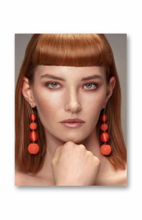 Beautiful redhead girl with glamour makeup.