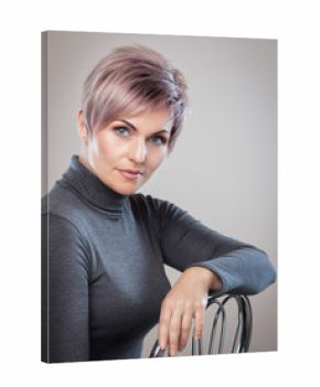 Portrait of a beautiful blonde woman with beautiful make-up and short haircut after dyeing hair in a hairdressing salon.