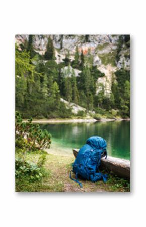 Hiking backpack at lake in Alp mountains. Camping and trekking outdoor equipment