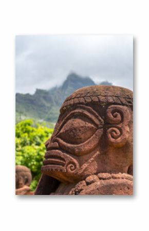Ancient tiki statue with Mount Temetiu, Hiva Oa, French Polynesia