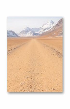 Tan Sand Desert Road Leading to Snowy Mountains Under Clear Sky