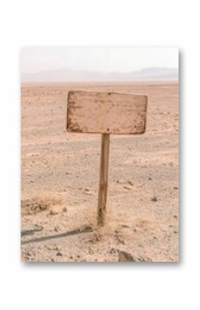 Weathered Wooden Road Sign in a Desolate Desert Landscape