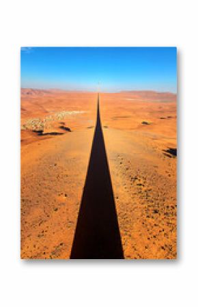 Long Shadow of Distant Tower in Dry Desert Landscape