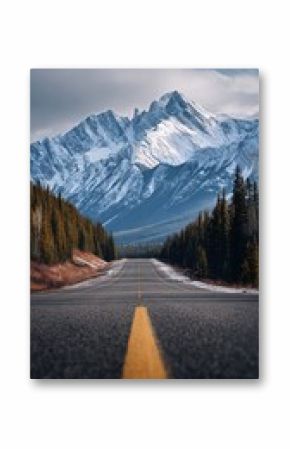Majestic Mountain Road Under Cloudy Skies With Snow-Capped Peaks Visible in the Background