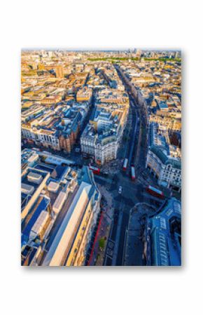 Aerial view of Oxford Circus in London with busy streets, iconic architecture, and red double-decker buses on a clear, sunny day