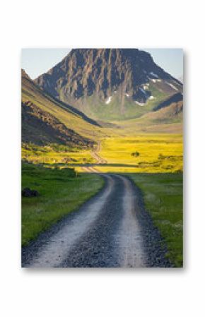 Winding gravel road cuts through lush green tundra with distant mountain peaks. A serene natural path through untouched wilderness, symbolizing exploration and peaceful solitude.  