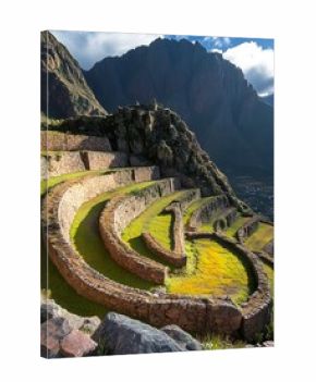 Ancient agricultural terraces winding across the hillside with mountains in the background.