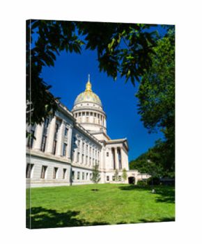 West Virginia State Capitol building in Charleston, West Virginia, United States. Designed by architect Cass Gilbert, the landmark is noted for its 23-karat gold-leaf dome, seen here framed by tree
