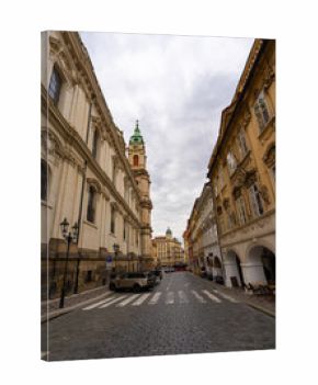 St Nicholas Church Tower on Cobblestone Street in Prague.