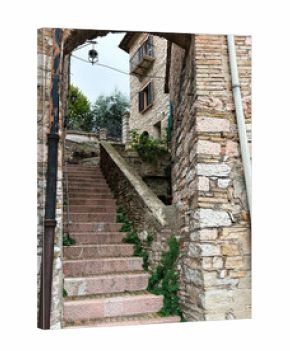 Stone archway and pink stone stairs in Assisi Italy create a historic alleyway scene