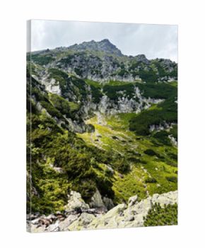 Hiking in Zakopane Poland through rugged mountains and green alpine meadows under dramatic skies