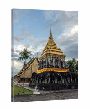 Majestic golden Chedi Chang Lom at Wat Chiang Man, Chiang Mai, Thailand. This revered Buddhist temple features traditional Lanna architecture, intricate details, and a unique elephant-sculpted base.