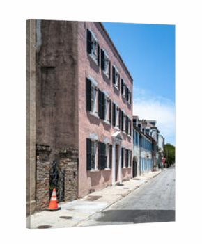 Historic pastel townhouse façade on a quiet street in Charleston, South Carolina