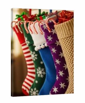 Colorful christmas stockings hanging on a mantelpiece with candy canes and gifts inside them for the holidays