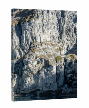 Tall Cliffs Catch Shadow And Light Over Oeschinen Lake