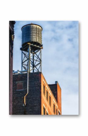 Old water tank tower over building in New York City