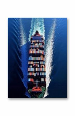 Aerial perspective of a fully loaded container ship navigating through calm ocean waters, showcasing global trade and maritime logistics.