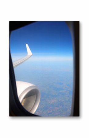 white clouds from above and a piece of wing during transoceanic flight seen from the window of an airplane