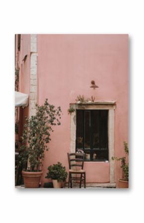 Charming Outdoor Seating by Pink Wall