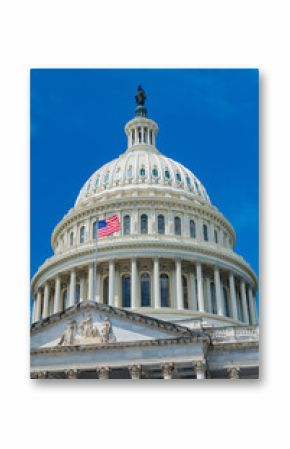Capitol dome against the blue sky in Washington, D.C. and the U.S. flag in the wind.