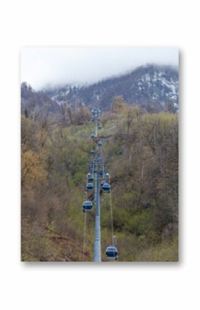 A long cable with many cable cars on it