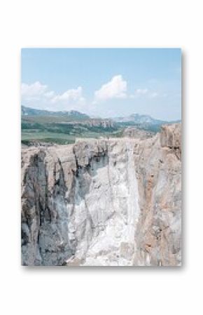 Wide Angle View of Craggy Cliffs and Sheer Rock Waterfall