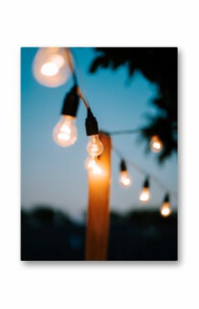 Warm glow of string lights illuminating a cozy outdoor space at dusk