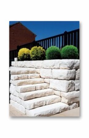 White Stone Steps and Retaining Wall with Green Shrubs